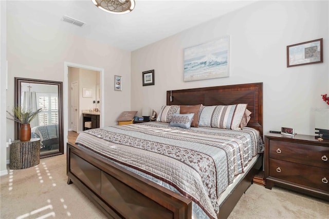 carpeted bedroom featuring ensuite bathroom