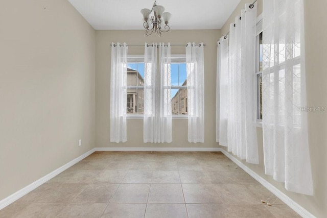 tiled empty room with a chandelier