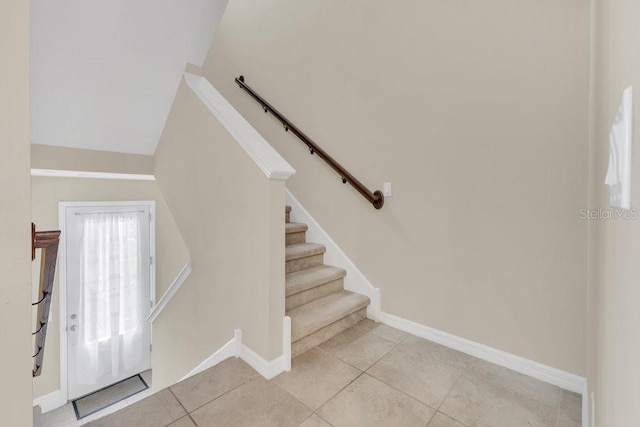 stairway featuring tile patterned flooring