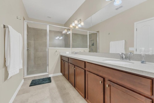 bathroom with tile patterned floors, vanity, and a shower with shower door