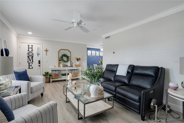 living room featuring crown molding, a textured ceiling, ceiling fan, and light wood-type flooring