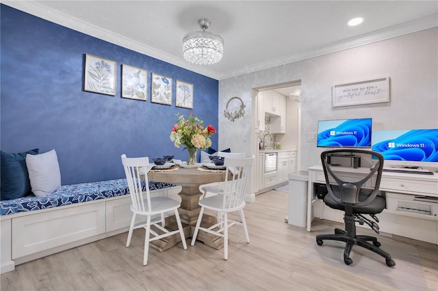 home office featuring crown molding, a chandelier, sink, and light wood-type flooring