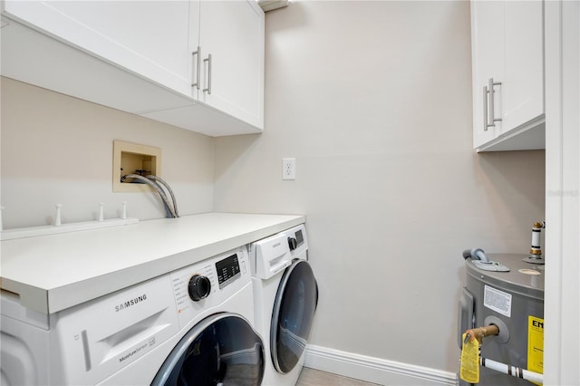 laundry room featuring electric water heater, cabinets, and washing machine and clothes dryer