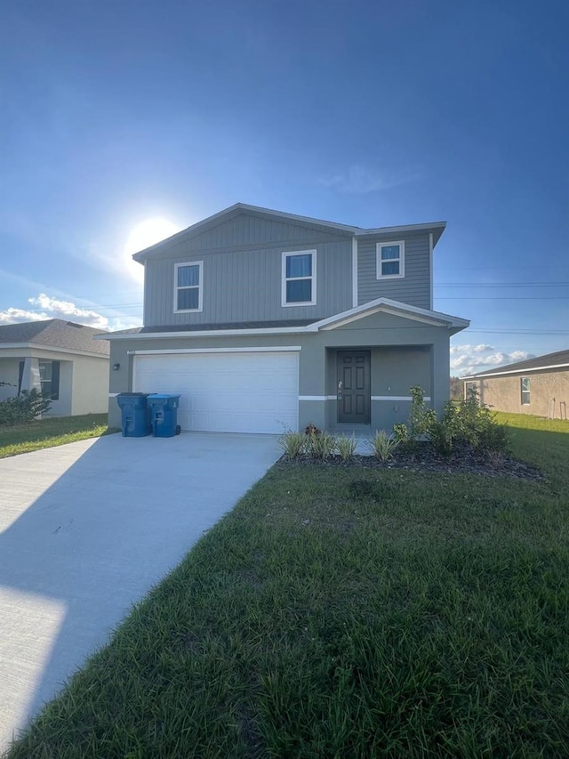 front facade with a garage and a front yard