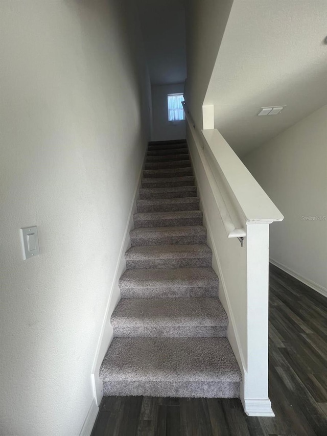 stairs with hardwood / wood-style floors