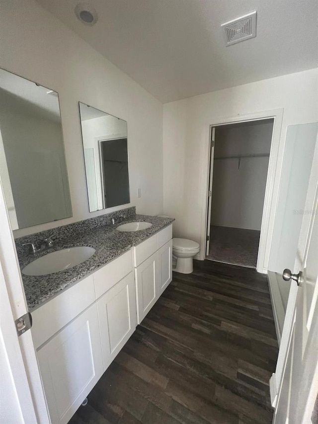 bathroom featuring hardwood / wood-style flooring, vanity, and toilet