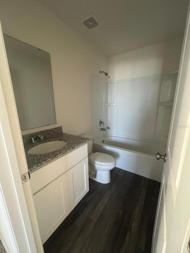 full bathroom featuring vanity, hardwood / wood-style floors,  shower combination, and toilet