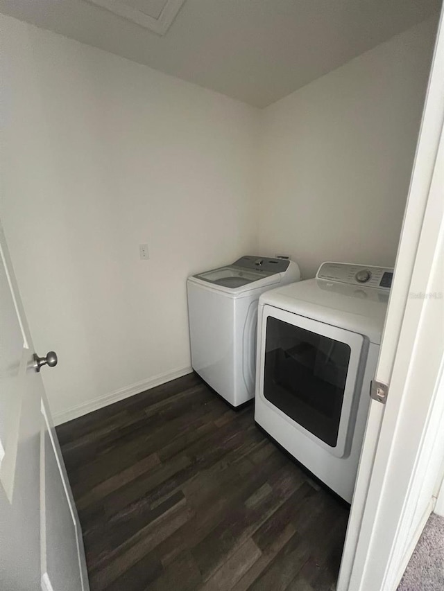 laundry area with dark wood-type flooring and washing machine and dryer