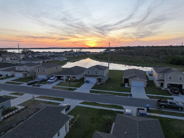 aerial view at dusk with a water view