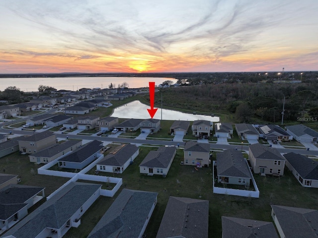 aerial view at dusk with a water view