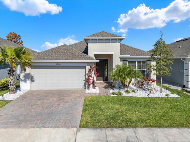 view of front facade with a garage and a front lawn