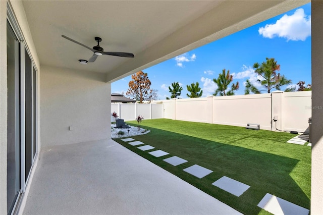 view of yard featuring a patio and ceiling fan