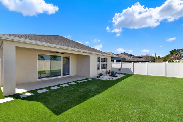 back of house with a yard and a patio area