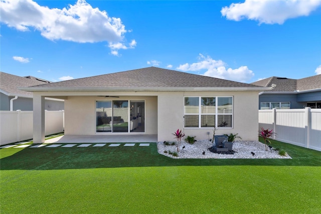 back of property featuring a lawn and a patio area