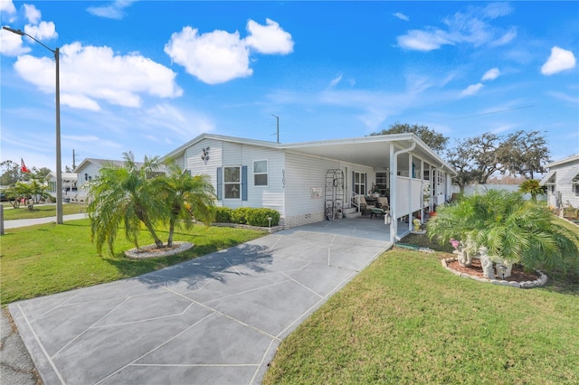 view of front of house with a carport and a front lawn