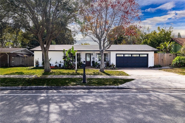 ranch-style home featuring a garage and a front yard