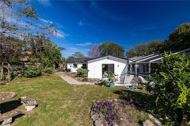 view of yard featuring a patio and glass enclosure