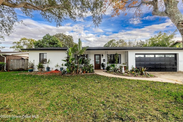 single story home with a garage, a front yard, and covered porch