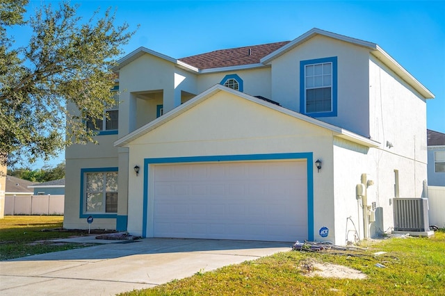 front of property with a garage and central air condition unit