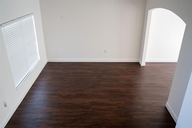 spare room featuring dark hardwood / wood-style floors