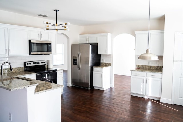 kitchen with white cabinetry, decorative light fixtures, dark hardwood / wood-style flooring, stainless steel appliances, and light stone countertops