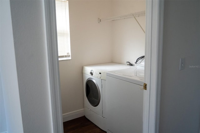 washroom with dark wood-type flooring and washing machine and dryer