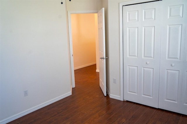 hallway with dark hardwood / wood-style flooring