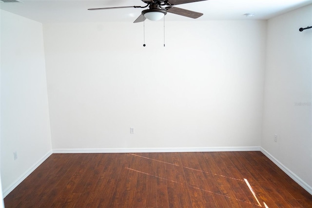 spare room featuring dark hardwood / wood-style floors and ceiling fan