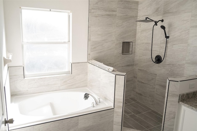 bathroom with separate shower and tub and plenty of natural light