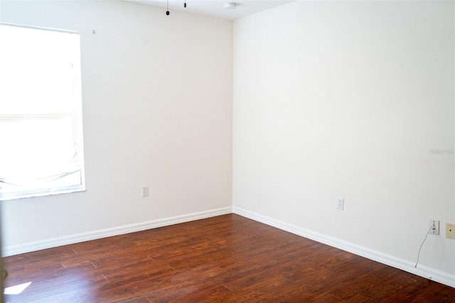 spare room with dark wood-type flooring