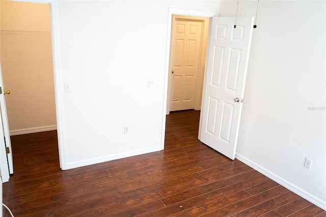 empty room with dark hardwood / wood-style floors