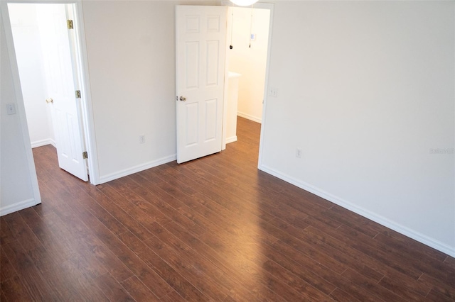 empty room featuring dark wood-type flooring