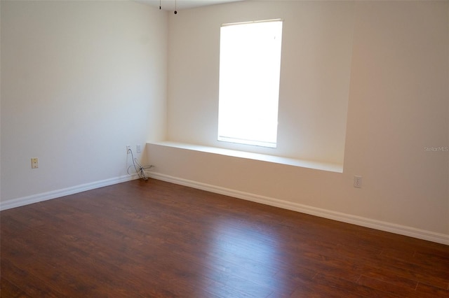 empty room with dark hardwood / wood-style floors