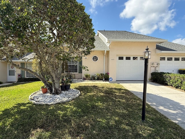 view of front of home with a garage and a front yard