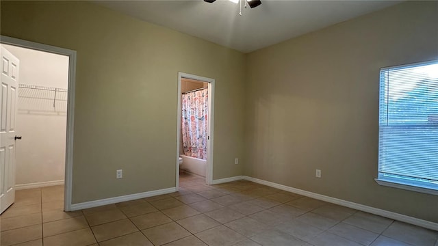 spare room with light tile patterned floors and ceiling fan