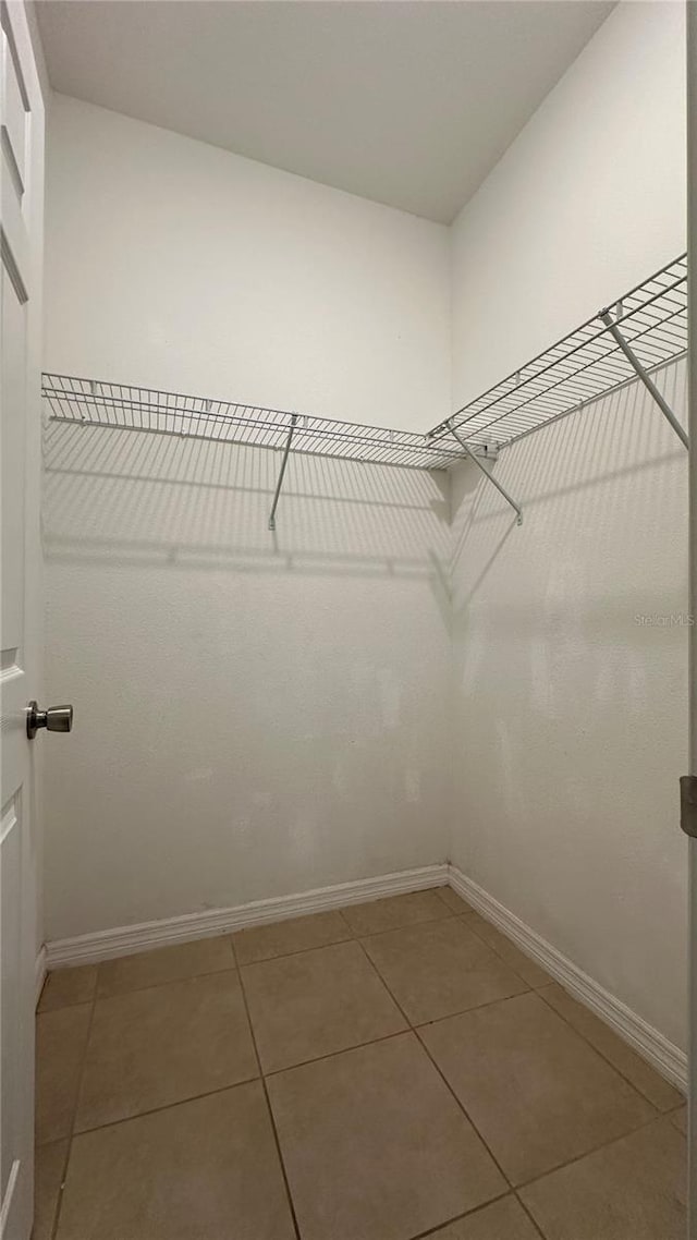 spacious closet featuring tile patterned floors