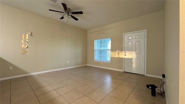 spare room with ceiling fan and light tile patterned flooring