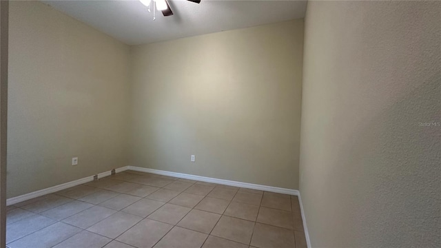 spare room with light tile patterned floors and ceiling fan