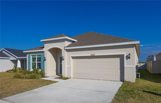 view of front facade featuring a garage and a front lawn