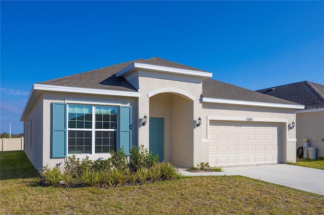 view of front of house with a garage and a front lawn