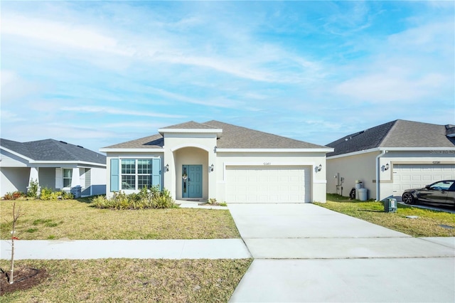 single story home featuring a garage and a front yard