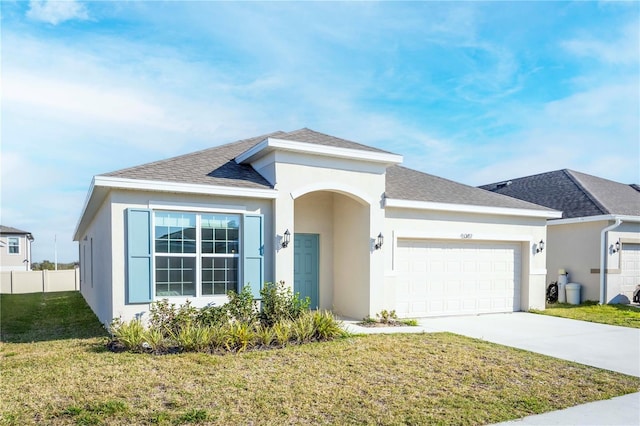 view of front of property featuring a garage and a front yard