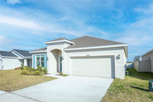 view of front of property with a garage and a front yard