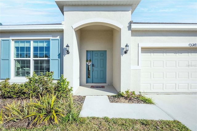 view of exterior entry featuring a garage