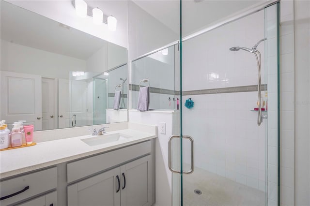 bathroom with vanity and a shower with shower door