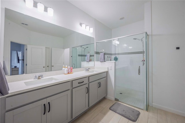 bathroom featuring vanity and a shower with shower door