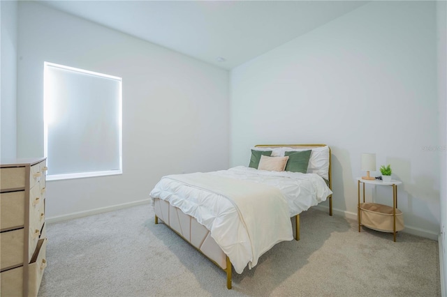 bedroom featuring light carpet