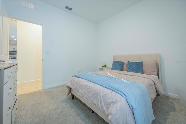 bedroom featuring light carpet