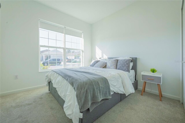 carpeted bedroom featuring vaulted ceiling