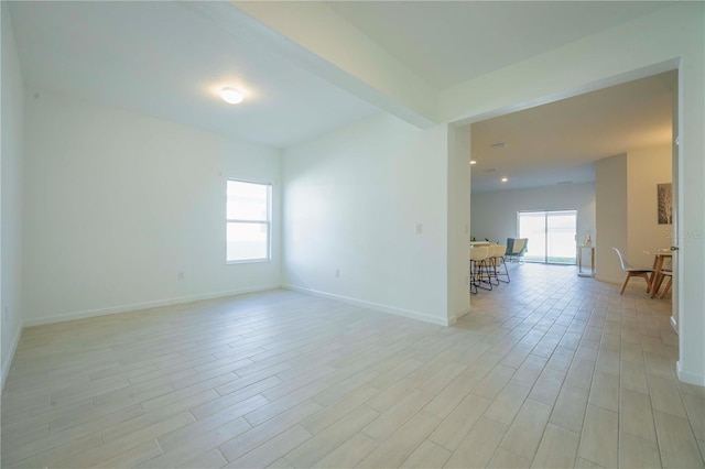 spare room featuring a healthy amount of sunlight and light hardwood / wood-style flooring